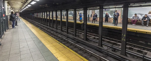 People wait at subway station Wall street