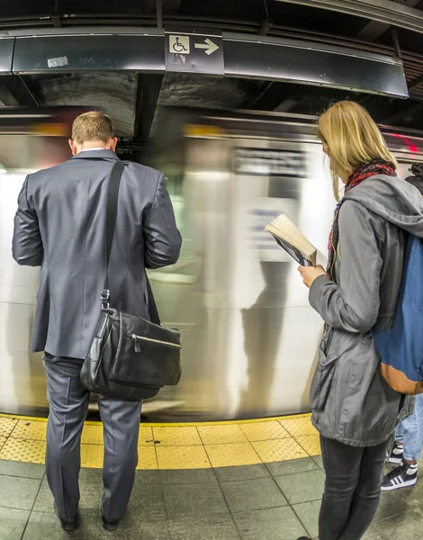 People wait at subway station times square in New York