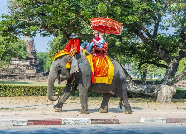 Tourists ride on an elephant in the Historical Park