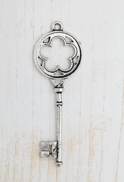 Antique key on wood background