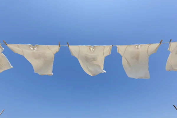 White t-shirts hanging on the clothesline