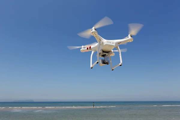 Drone quad copter with flying in the clear blue sky