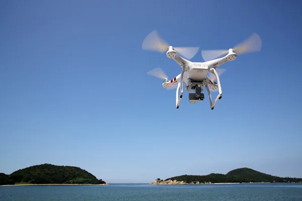 Drone flying with clear blue sky