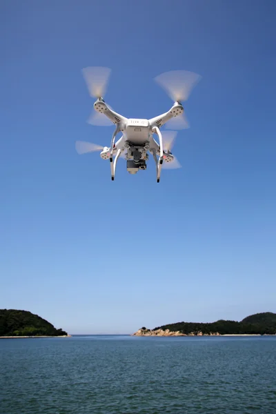 Drone flying with clear blue sky