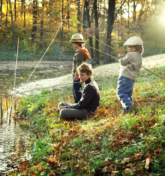 Happy boys go fishing on the river