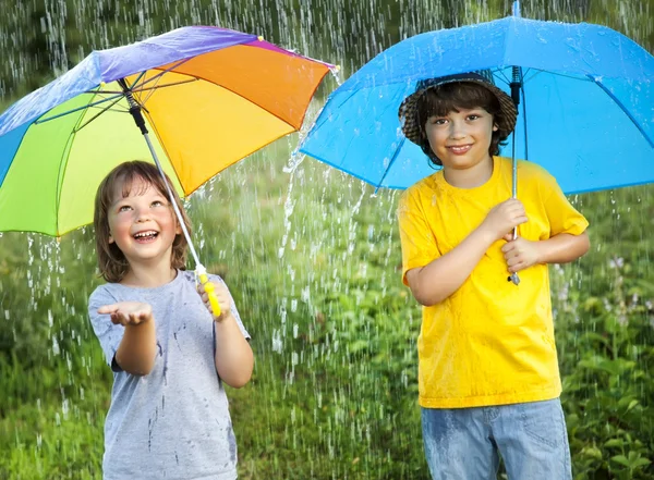 Happy brother with umbrella outdoors