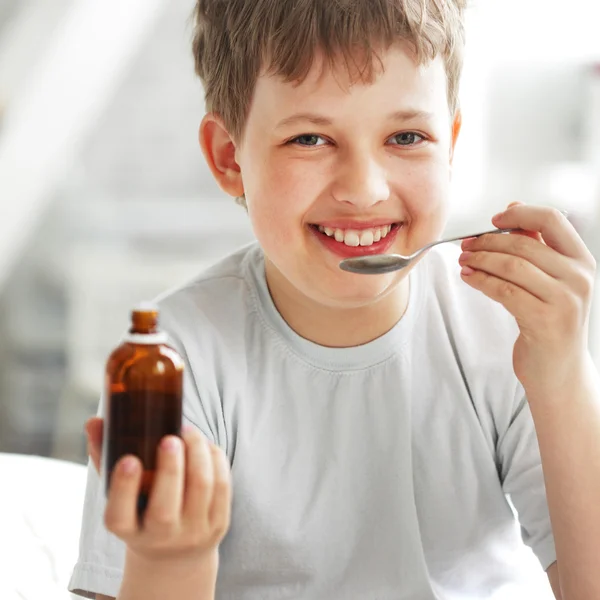 Boy drinking cough syrup