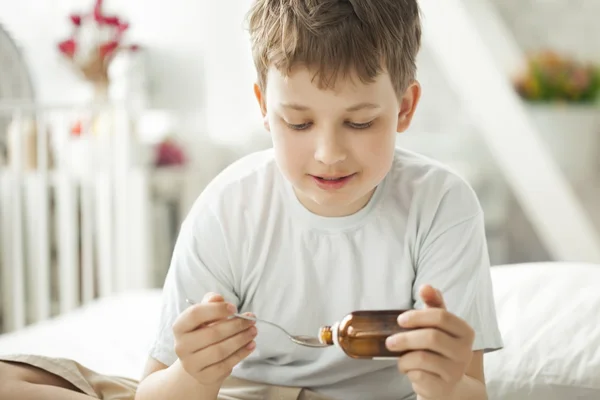 Boy drinking cough syrup