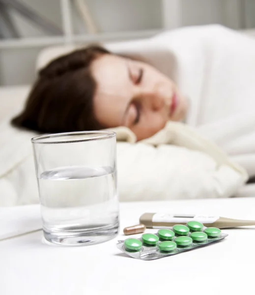 Girl lying near sick medicines