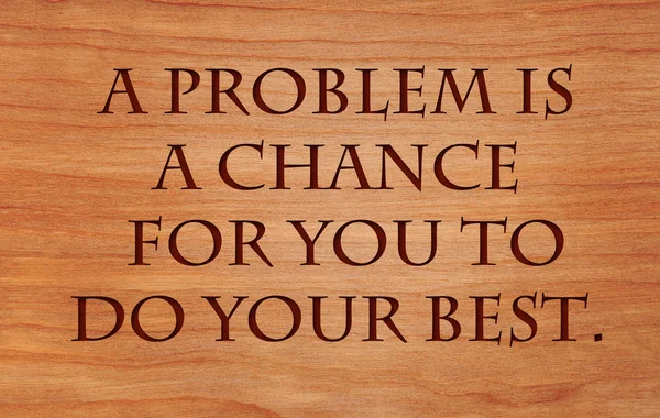 A problem is a chance for you to do your best. - quote on wooden red oak background