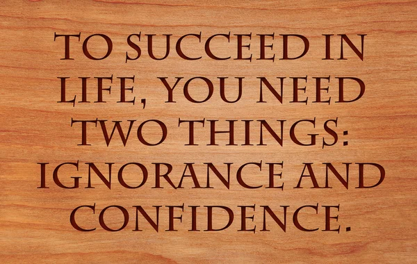 To succeed in life, you need two things: ignorance and confidence - quote on wooden red oak background
