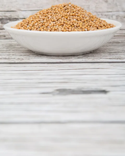 Mustard seeds in the white bowl