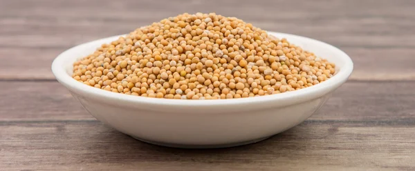 Mustard seeds in the white bowl