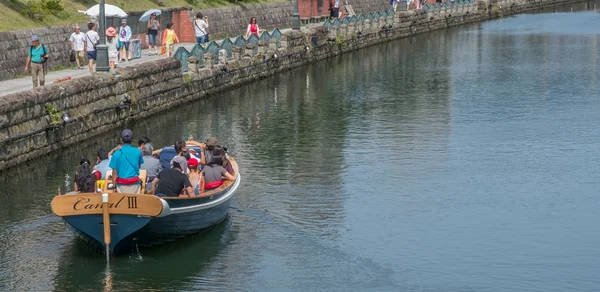 Tourists sightseeing in a tourist boat in Otaru Canals, Japan