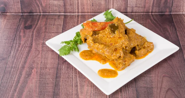 Lamb curry in white plate