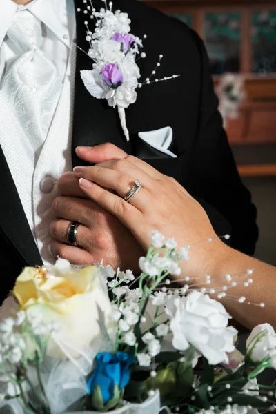 Newly married bride and groom hands with rings