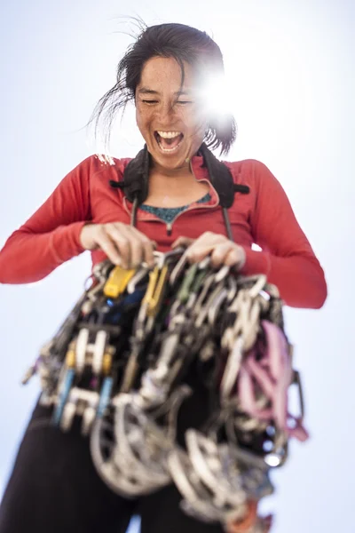 Female climber racking gear.