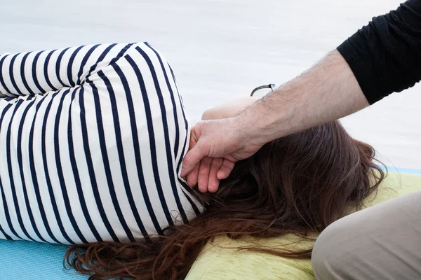 Man\'s hand manipulates on the woman\'s neck