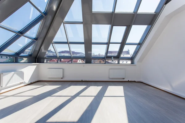 The spacious interior room unfurnished with a glass ceiling