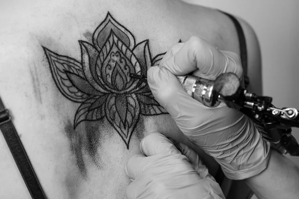 Tattoo flower on the woman\'s back