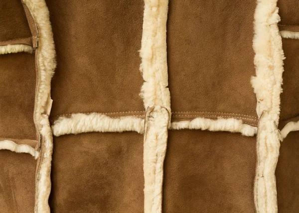 Two peaces of sheepskin are sewn together