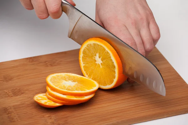 Cutting the fruit knife on a chopping board
