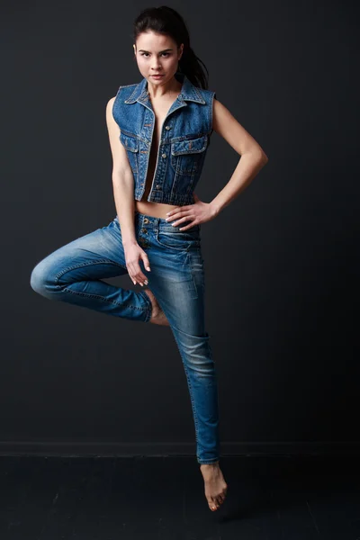 woman in jeans vest and pants  jumping