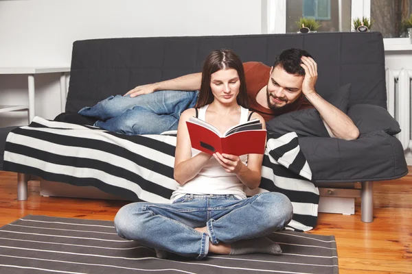 Young couple reading a book