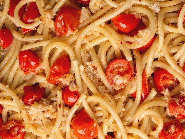Italian crab and cherry tomato spaghetti pasta food background