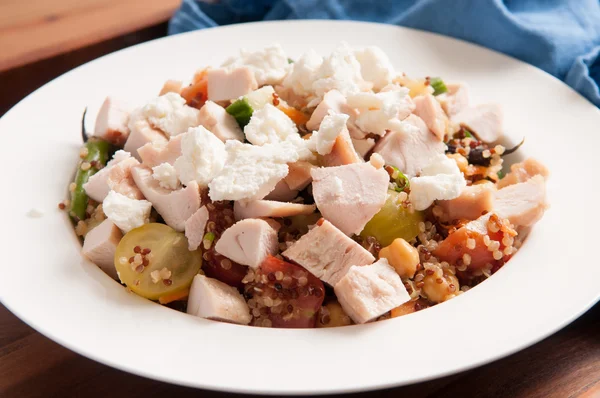 Chickpea and quinoa salad with diced chicken and goat cheese