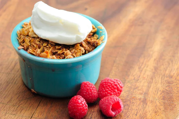 Single serving of apple raspberry crumble with whipped cream