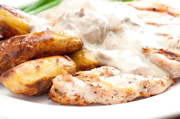 Grilled chicken with mushroom sauce and fingerling potatoes