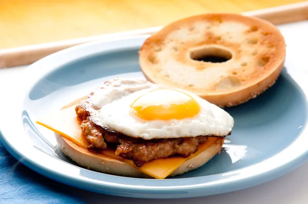 Egg with sausage patty on bagel