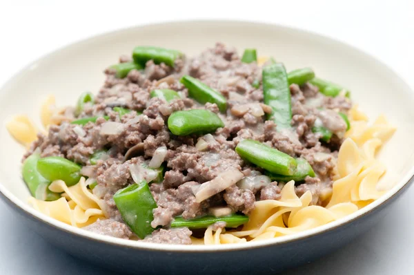 Ground beef hamburger stroganoff with chopped snap peas and broa