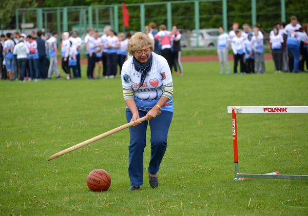 KALININGRAD, RUSSIA - MAY 15, 2016: The woman of average years rolls before herself a ball by means of a stick at the competitions \