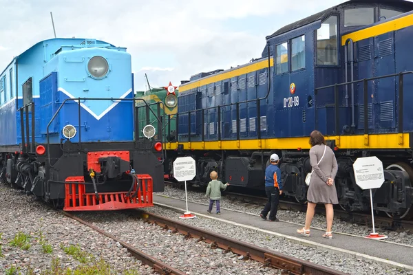 ST. PETERSBURG, RUSSIA - JULY 23, 2015: People examine an old locomotive in the museum of the railroad