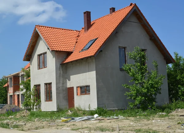 Construction of a cottage with a red tile roof