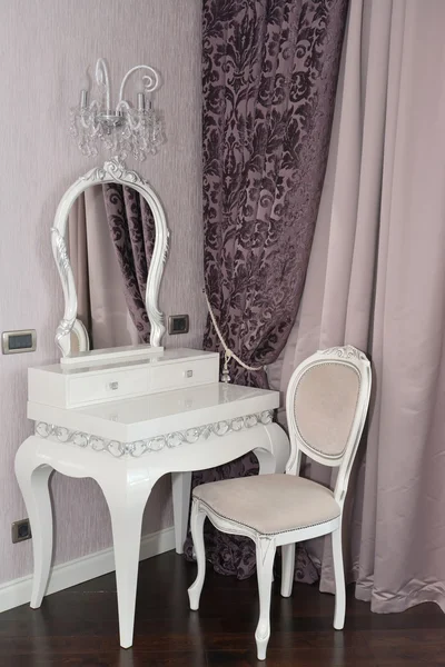 White dressing table and chair in a living room. Modern classics