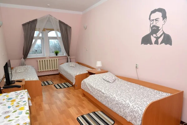 Triple hotel room with a portrait of the Russian writer A. P. Ch