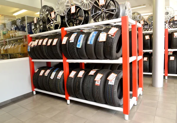 KALININGRAD, RUSSIA - OCTOBER 03. 2015: A rack with tires and rims in a trading floor. Shop of an autotechnical center