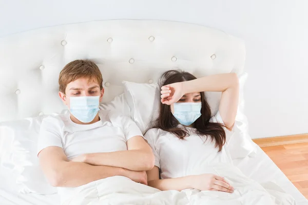 Couple in bed suffering common cold