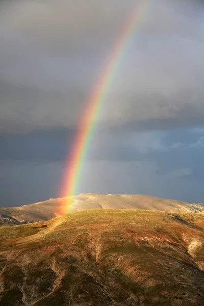Rainbow after the rain and mountain