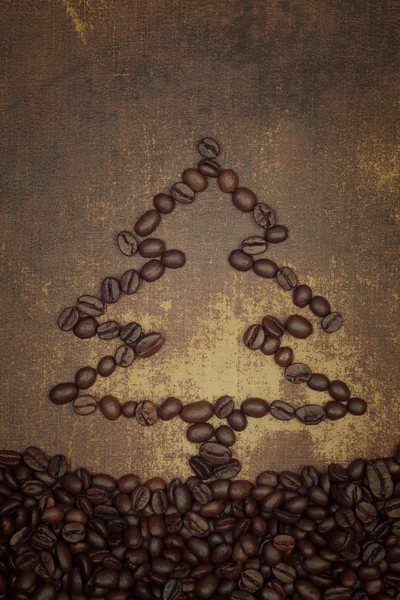 A christmas tree out line made out of  roasted coffee beans on s