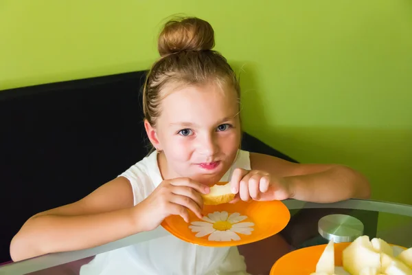 Cute girl eating melon