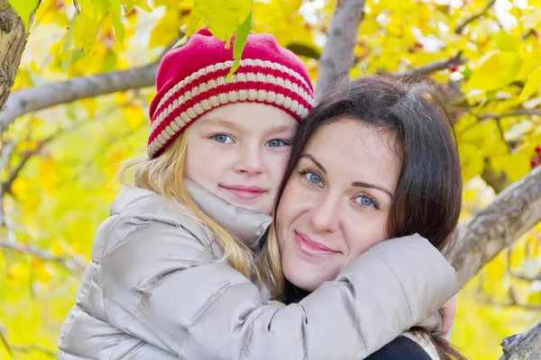 Happy mother and daughter in autumn