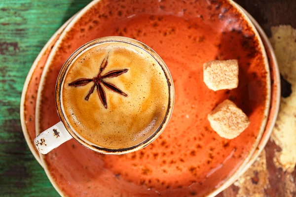 A cup of spiced coffee with anise star