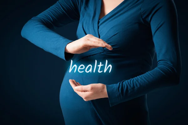 Pregnant woman with protective gesture and health