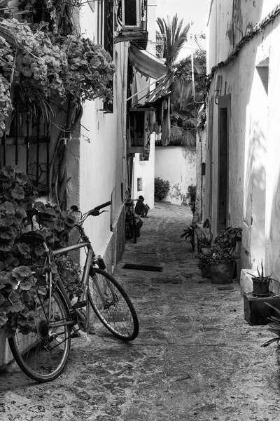 Typical old Mediterranean alley between old houses with bike abn