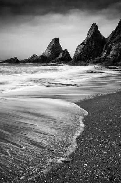 Landscape seascape of jagged and rugged rocks on coastline with