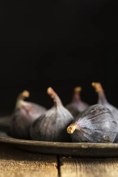 Fresh figs in moody natural lighting set with vintage retro style
